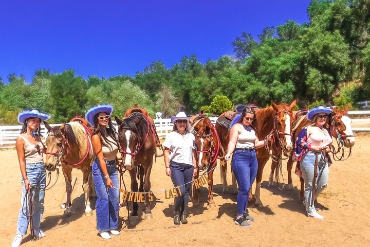 a group of people standing on a dirt road