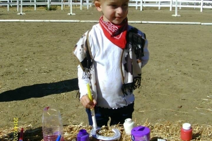 a little boy that is standing in the grass